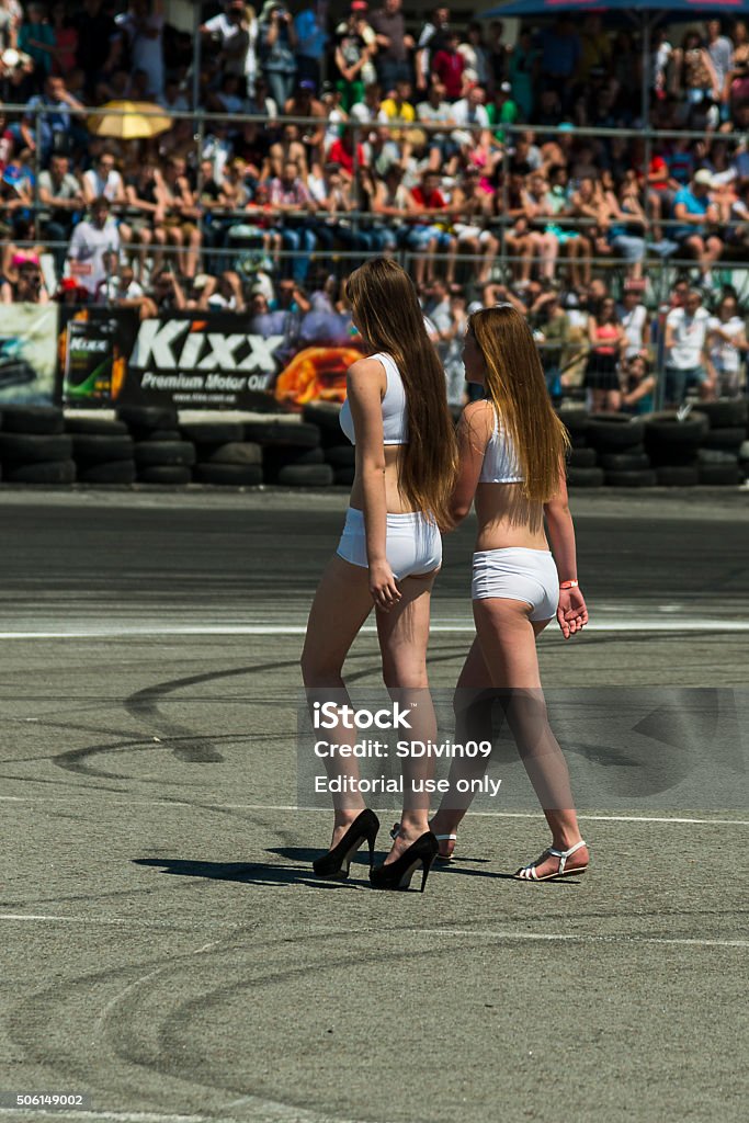 Pit girls go on the track Lviv, Ukraine - June 7, 2015: Pit girls go on the track before the start of the championship of drifting near Arena - Lviv stadium in Lviv, Ukraine. Car Stock Photo