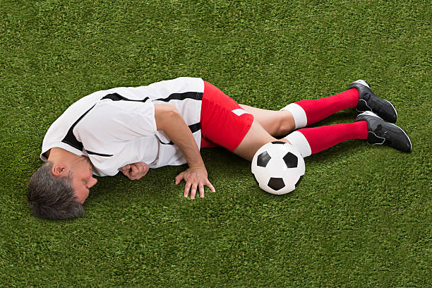 istock Injured Soccer Player Lying On Grass 506150956