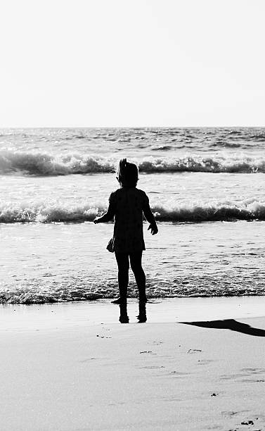 istock girl playing on the beach 506152271