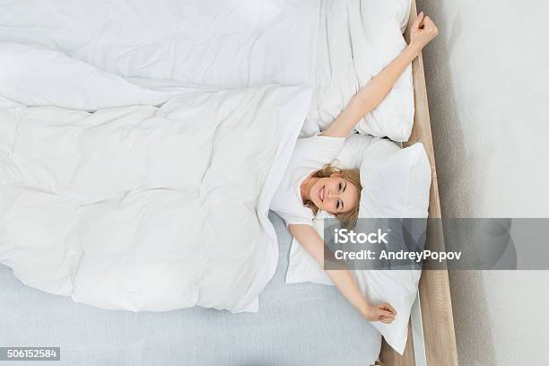 Woman Waking Up In Bed Stock Photo - Download Image Now - Adult, Bed - Furniture, Bedroom