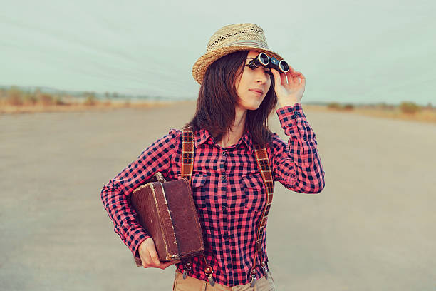 istock Woman looks away through binoculars 506152649