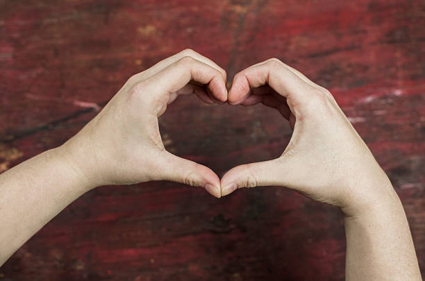istock high contrast heart symbol made by two hands concept 506163304