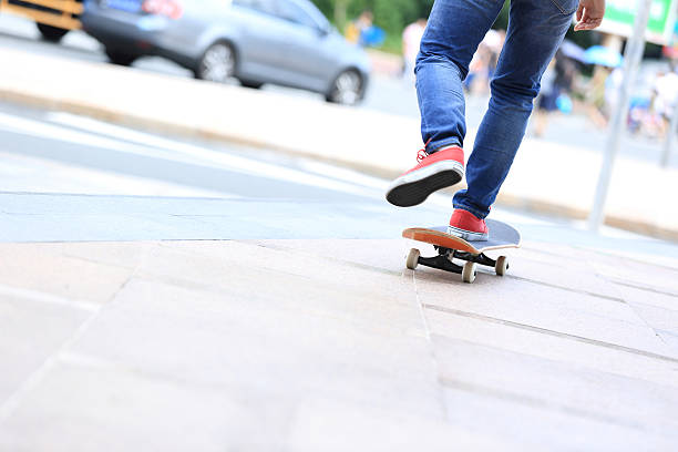 istock young skateboarder legs riding on skateboard on city 506164782