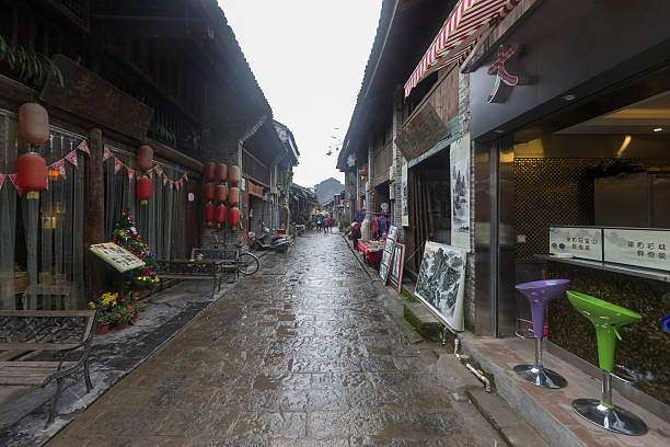 Xinping Ancien Town, Guilin, Yangshuo, Guangxi, China Xinping, Guangxi, China - December 22, 2015: Ancient town tourist attraction in narrow street .Stores on both sides. hillary clinton stock pictures, royalty-free photos & images