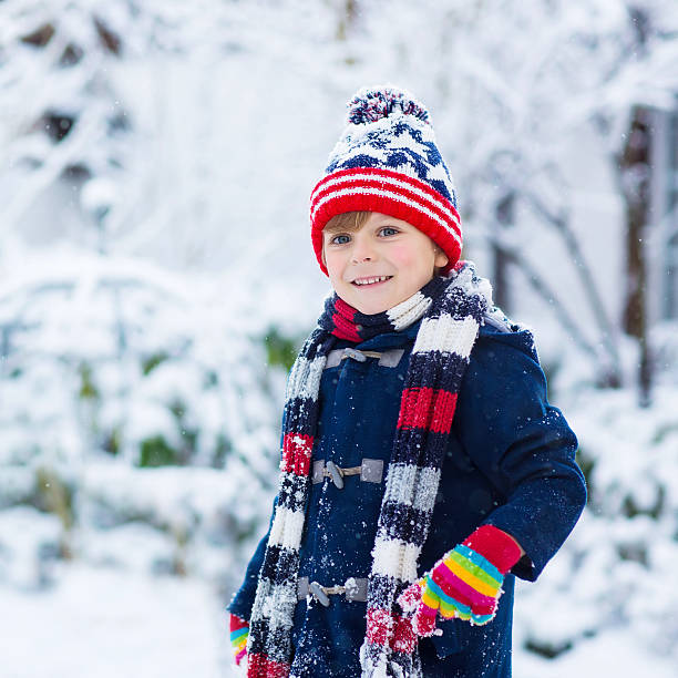 istock Happy child having fun with snow in winter 506166412