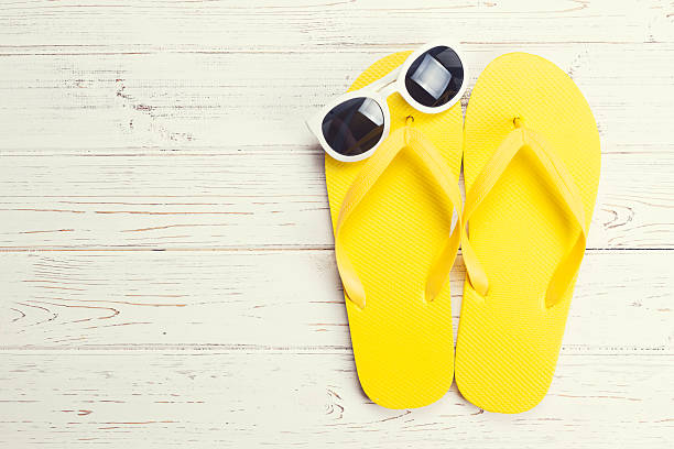 istock Yellow flip flops and sunglasses 506166794