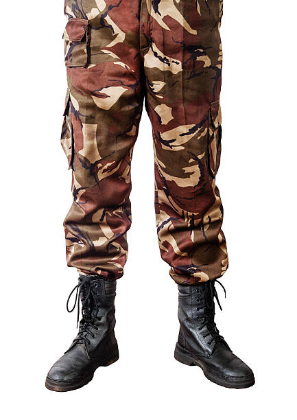 Men feet in camouflage pants and army boots stock photo