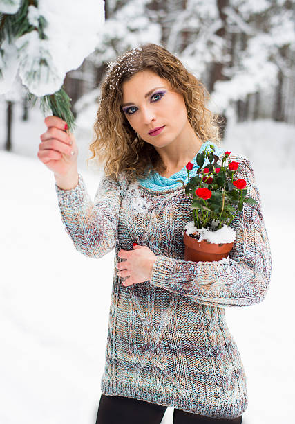 istock The woman poses outdoors in the winter wood, in a knitted pullover 506167600