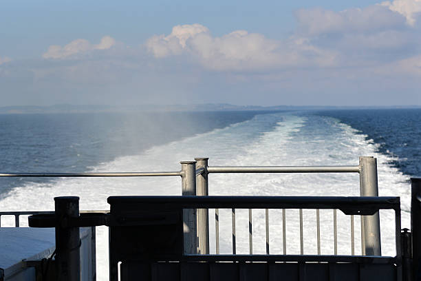 Denish Coast seen from the ship The Denish coast near Aarhus disappears in the mis of this high speed ferry denish stock pictures, royalty-free photos & images