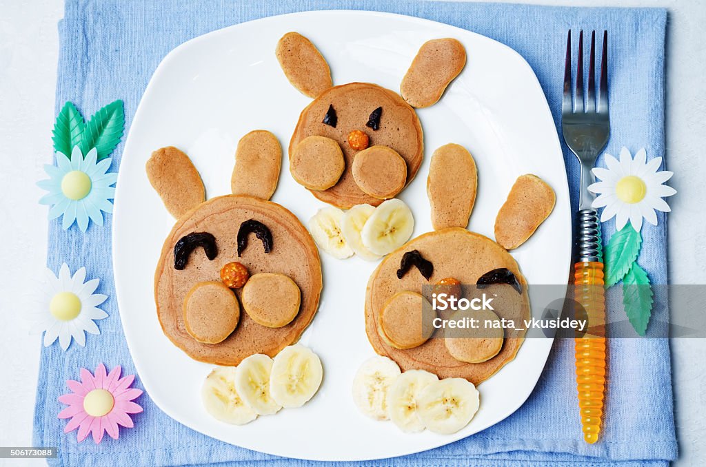 Pancake in the form of a rabbit for children Pancake in the form of a rabbit and dried apricots cashew carrots for breakfast for children for Easter. toning. selective Focus Crêpe - Pancake Stock Photo