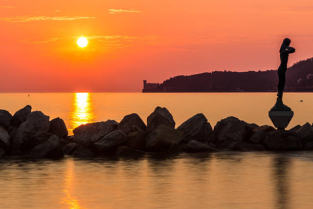 istock sunset behind the castle of Trieste 506174780