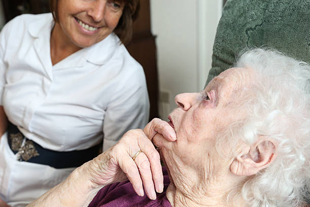istock Care worker nurse caring for an elderly woman 506175536