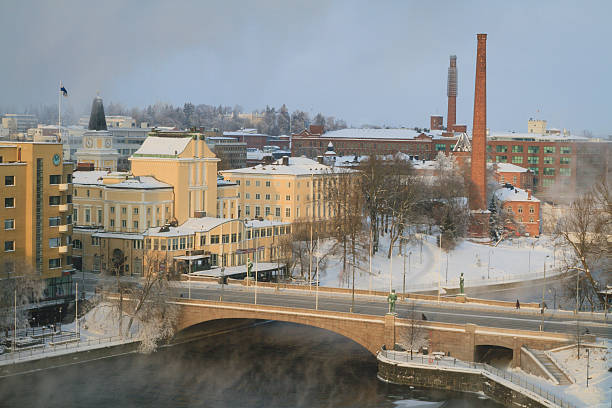 Tampere city center at cold winter morning with steam rising from river.