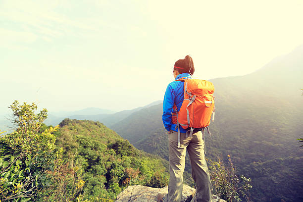 istock young woman backpacker hiking at mountain peak 506179336