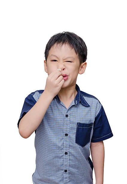 istock boy wipes his nose by tissue paper 506179718