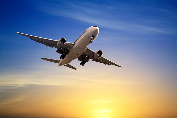 istock Jet Aeroplane Landing at Sunset Blue Yellow Copy Space 506187155