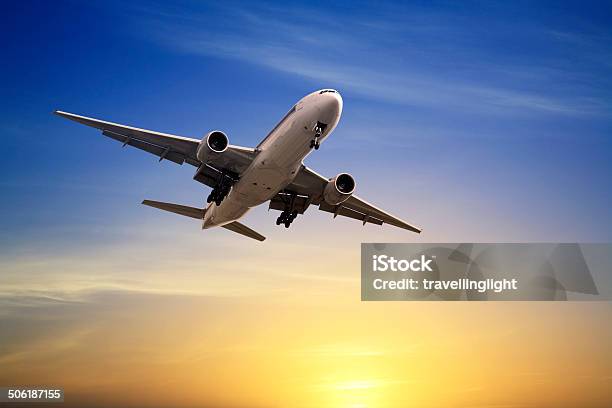 Jet Aeroplane Landing At Sunset Blue Yellow Copy Space Stock Photo - Download Image Now