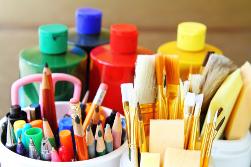 Artist painting supplies: paint brushes, sponge brushes, colored pencils, pens, markers and paint containers. Arts and crafts supplies.
