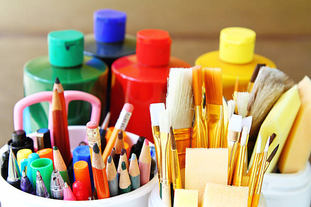 Art and drawing supplies Artist painting supplies: paint brushes, sponge brushes, colored pencils, pens, markers and paint containers. Arts and crafts supplies. art and craft stock pictures, royalty-free photos & images