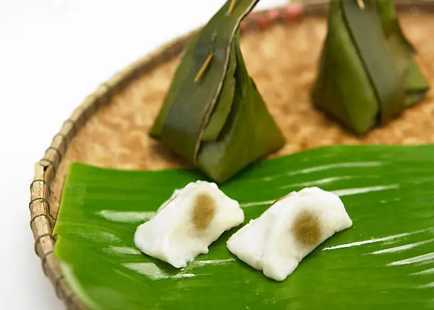 Thai traditional sticky rice dessert in banana leaf packaging.