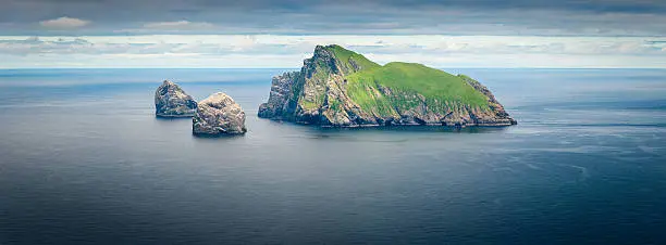 The precipitous rocky cliffs and steep green slopes of Boreray, the remote uninhabited island in the St. Kilda archipelago far off the western coast of the Outer Hebrides, Scotland. ProPhoto RGB profile for maximum color fidelity and gamut.