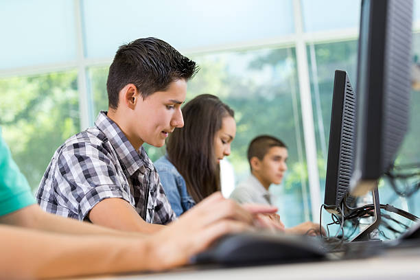 istock Teen students typing in high school computer lab classroom 506189907