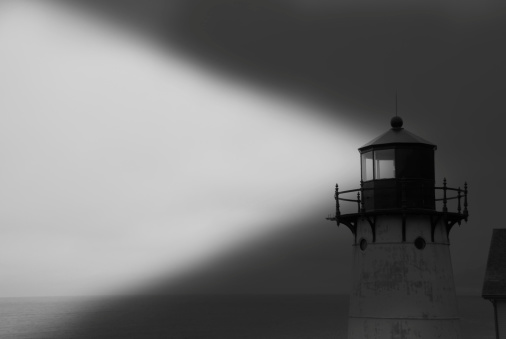 A black and white photo of a light house.