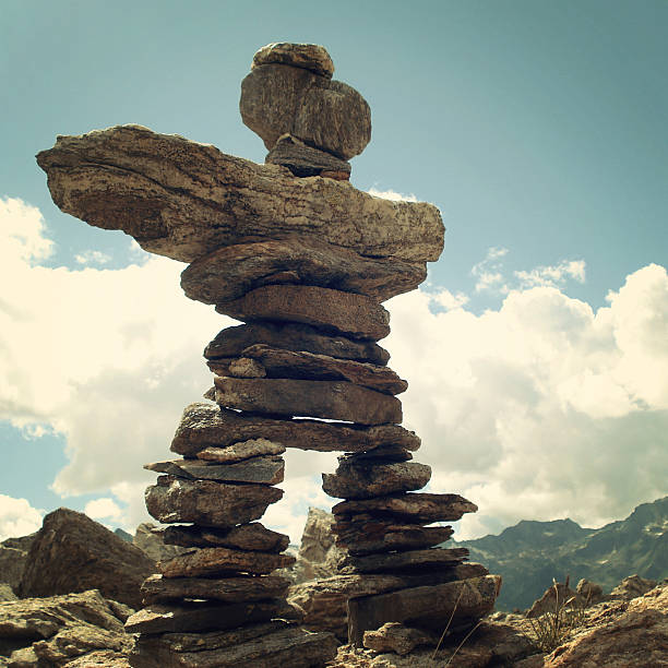 istock Man like stone pyramid. Trail Sign. Caucasus Mountains vintage effect. 506191309