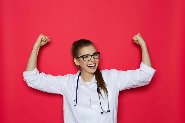 rire de femme médecin acclamations - arms outstretched arms raised women winning photos et images de collection