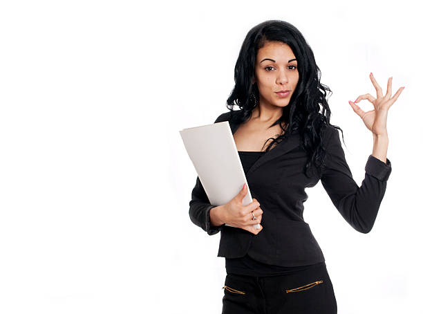 Young business woman giving the OK sign holding a folder stock photo