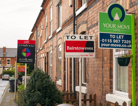 Nottingham, UK - March 26, 2014: Several property agency signs posted outside terraced houses in Beeston in the East Midlands city of Nottingham, England.