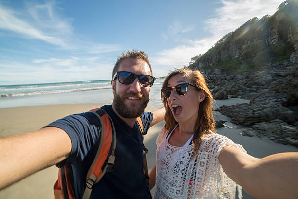 istock One young couple take selfie portrait on beach 506198426