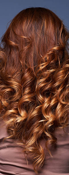 curly hair, rear view rear view on unrecognizable woman with curly red hair. ringlet stock pictures, royalty-free photos & images
