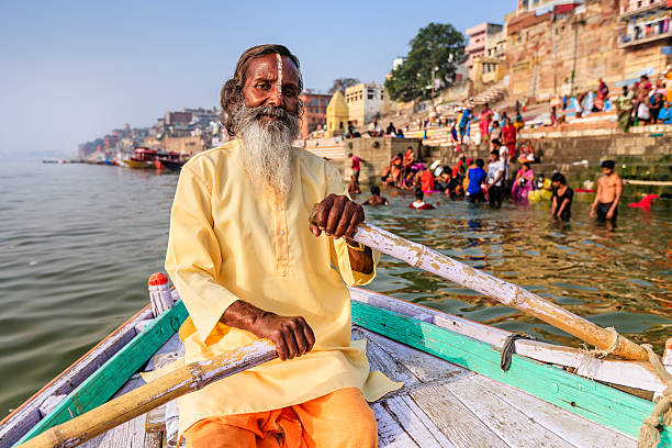 istock Sadhu rowing boat on the holy Ganges River in Varanasi 506201378
