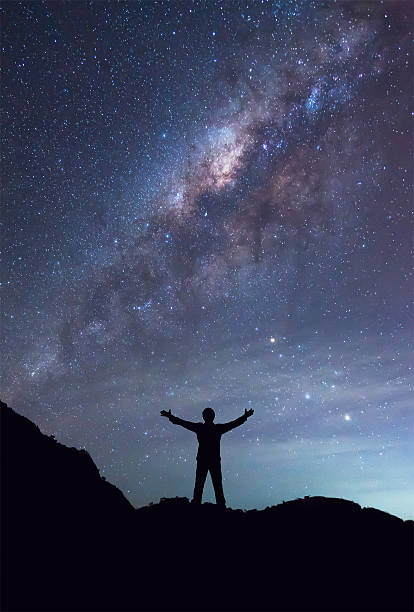 istock Man is standing next to the Milky Way galaxy 506202268