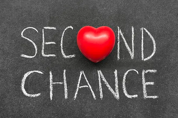 second chance phrase handwritten on blackboard with heart symbol instead of O