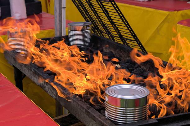 Lighting a flame on a barbecue grill.