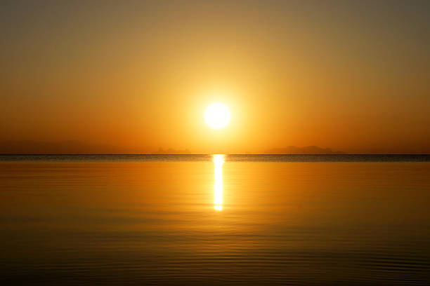 istock Sunset sky and big sun over the lake. 506212297