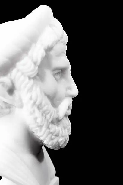 Pythagoras of Samos (570-490 B.C.E.) was an important Greek philosopher, mathematician, geometer and music theorist. Sculpture isolated on black background