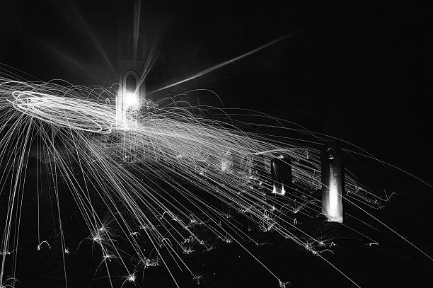 istock Glow Painted by fire in night (light painting) black & white 506215707