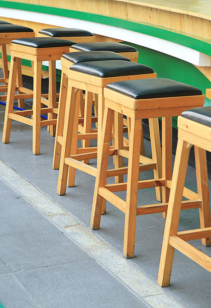 istock Lined up of wooden bar stools 506216278