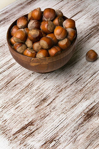 istock hazelnuts in wooden bowl on rustic background 506218620