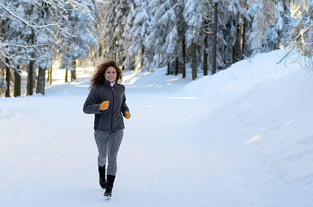 istock Fit young woman jogging in winter 506219854
