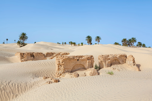 Sand Dunes near Douz (Kebili province) in Tunisia the gateway to the Sahara. Zaafrane, 12 km of Douz, where some ghostly ruins testify to a village swallowed up by the sands. Douz is a town in the Kebili Governorate in the south of Tunisia, known as the 