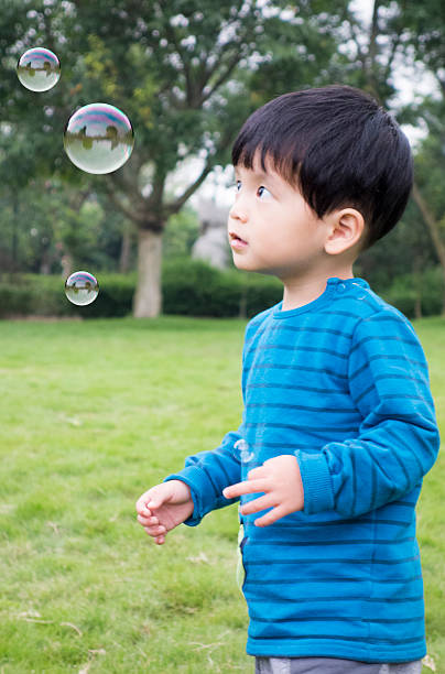 istock Cute asian boy playing with soup bubbles 506224236