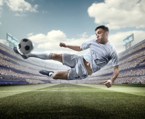 istock Soccer player kicking ball in stadium 506237664