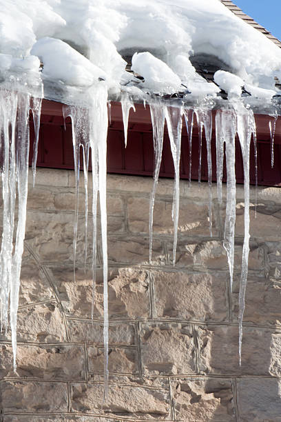 istock Close up of icicles on a stone building 506238018