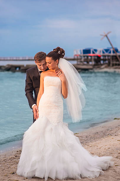 istock Beautiful newlyweds by thr sealine . 506238022