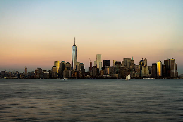 New York City Manhattan Skyline New York City skyline with urban skyscrapers at sunset liberty tower stock pictures, royalty-free photos & images