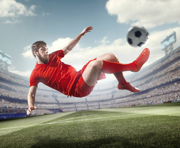 istock Soccer player kicking ball in stadium 506238052